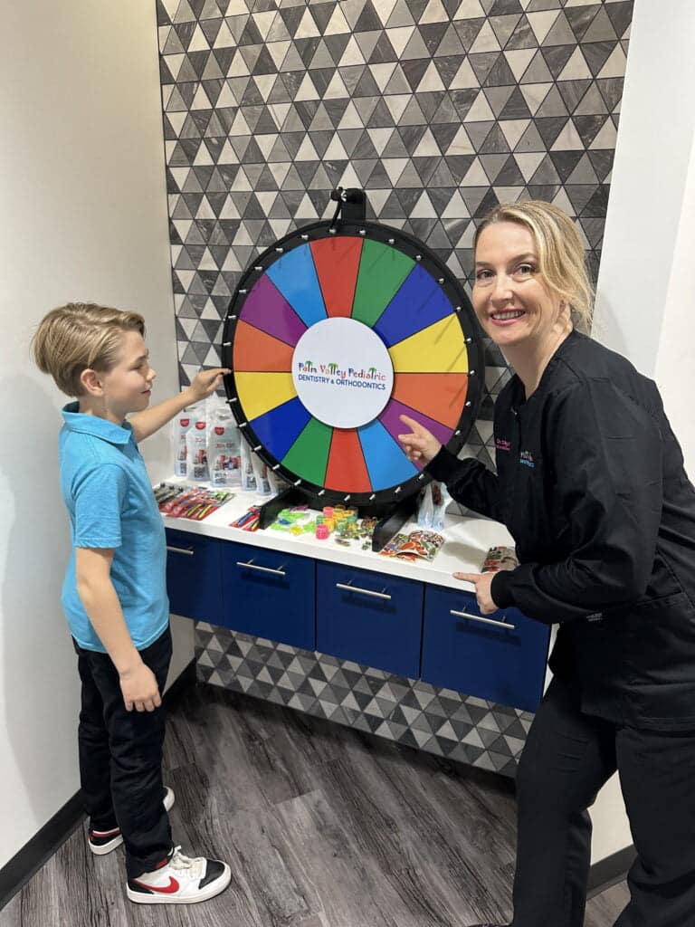 Fun Dental Experience Dr. Olga Dolghier Engages with Child Patient in Playful Game
