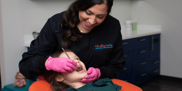 Pediatric dentist performing dental treatment on a girl in Scottsdale